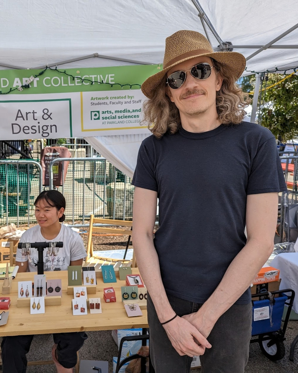Saxon Burns at his outdoor market booth with the Parkland Art Collective.