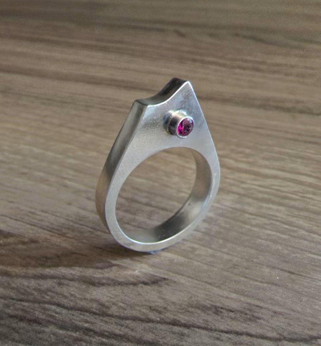 Summit Ring: sculptural sterling silver ring rising to a single peak, set with a lab-grown ruby.